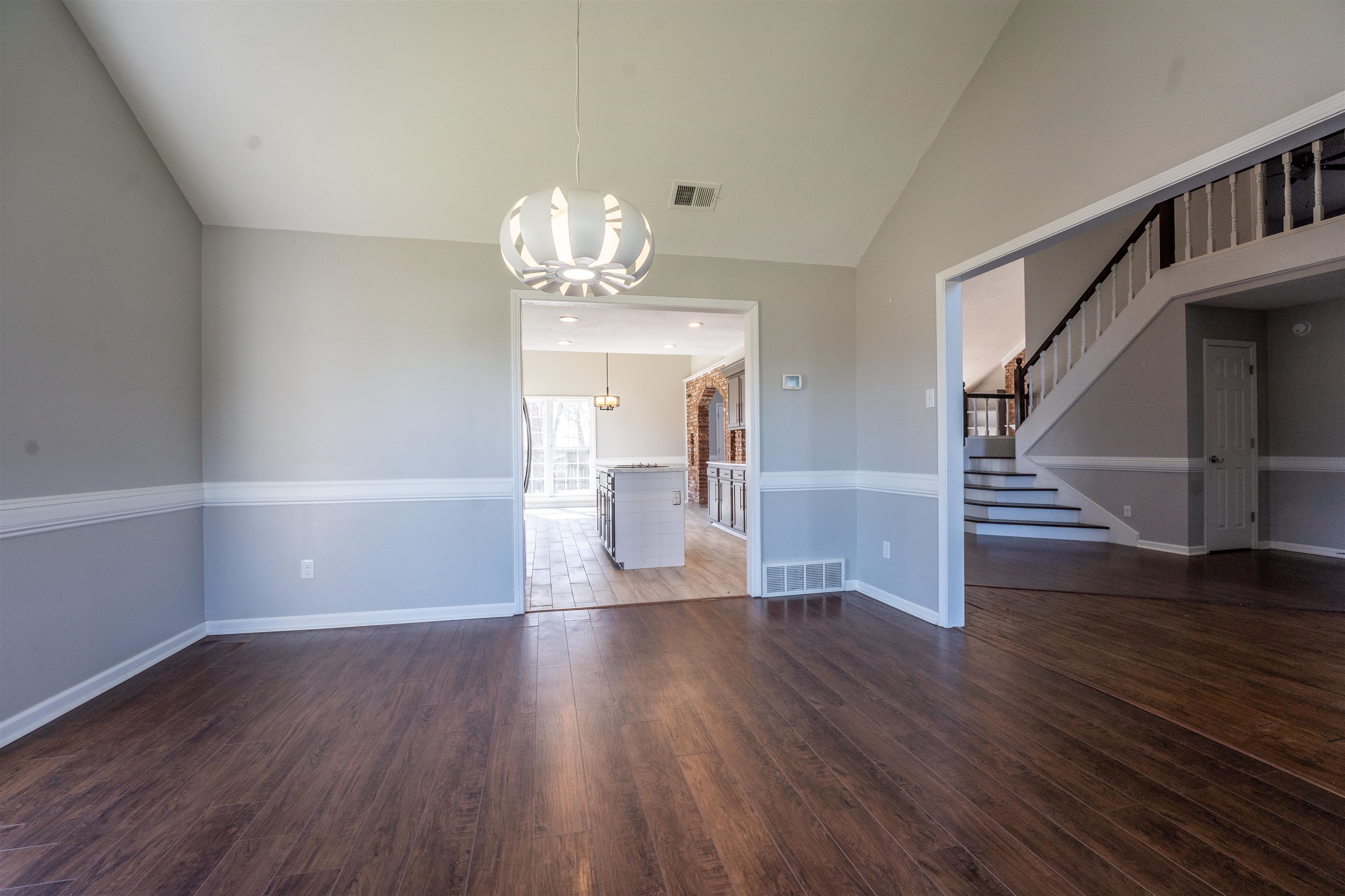 8747 Walnut Grove Road Memphis, TN 38018 - Photo 5 of 25 wooden floor in an empty room with a window