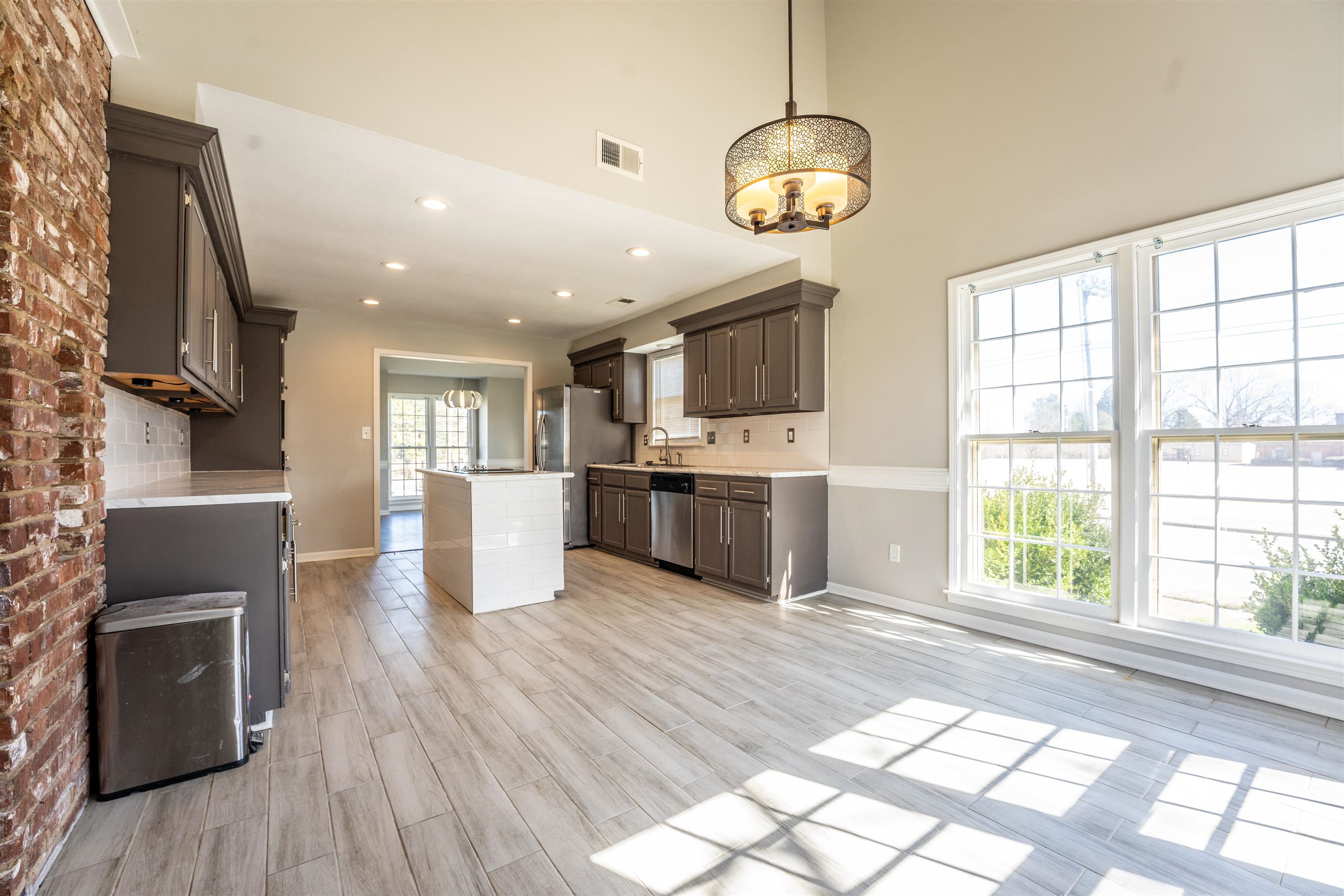 8747 Walnut Grove Road Memphis, TN 38018 - Photo 7 of 25 a large kitchen with stainless steel appliances granite countertop a stove and cabinets