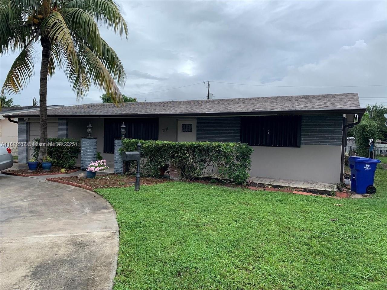 a front view of house with yard and outdoor seating