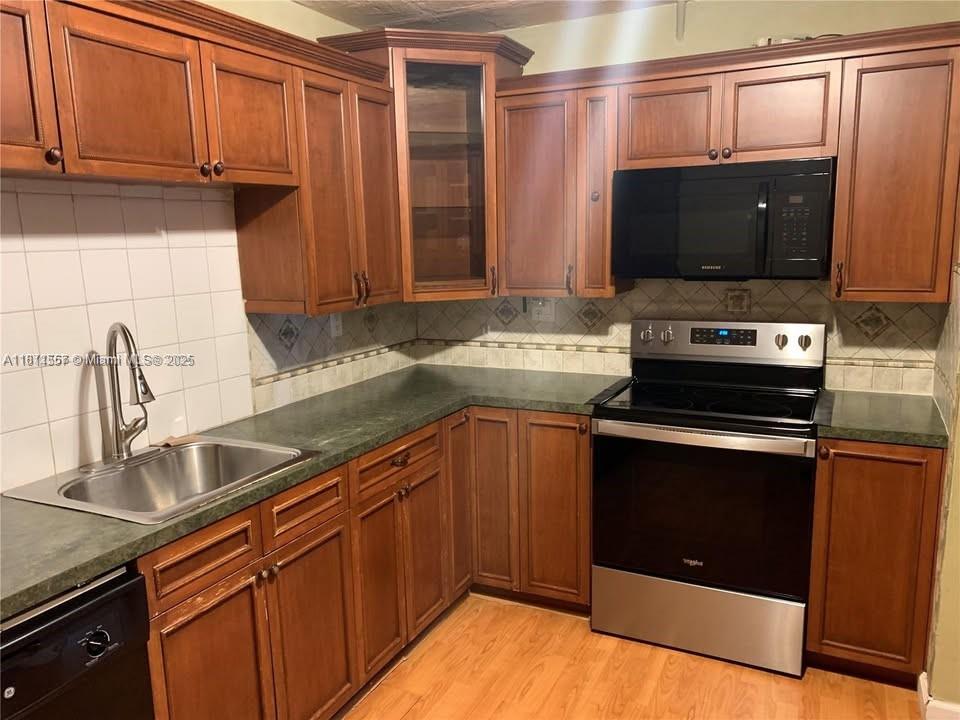 2701 Utopia Drive, Unit A Miramar, FL 33023 - Photo 2 of 6 a kitchen with stainless steel appliances a stove a sink and a microwave