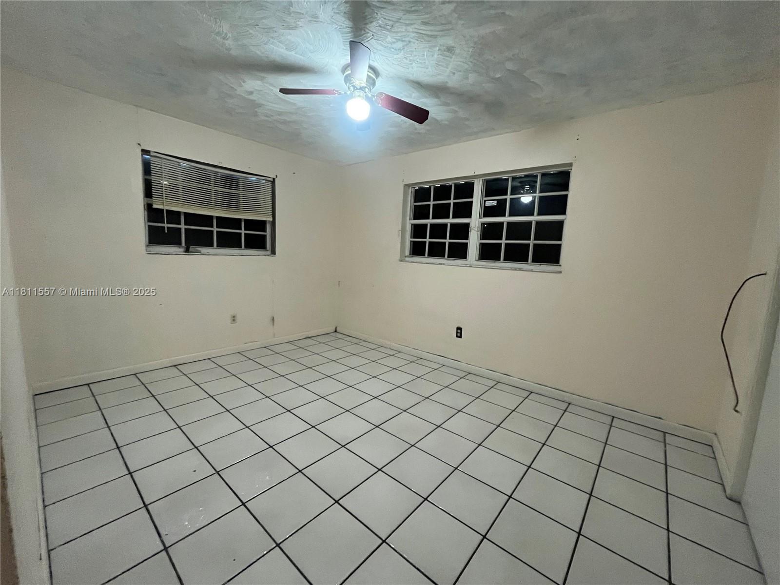 2701 Utopia Drive, Unit A Miramar, FL 33023 - Photo 4 of 6 a view of a livingroom with an empty space and a ceiling fan
