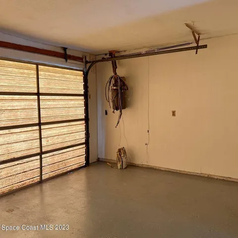 a view of a room with rack and a window