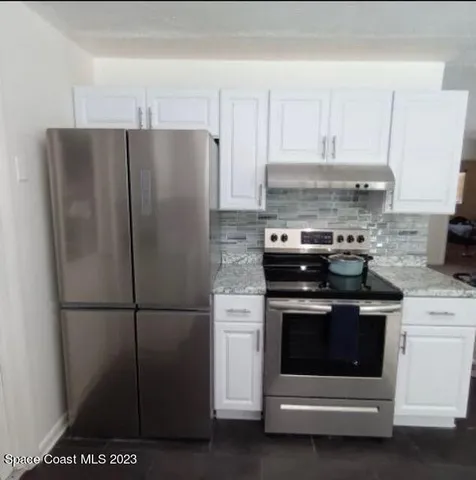 a kitchen with a stove and a refrigerator