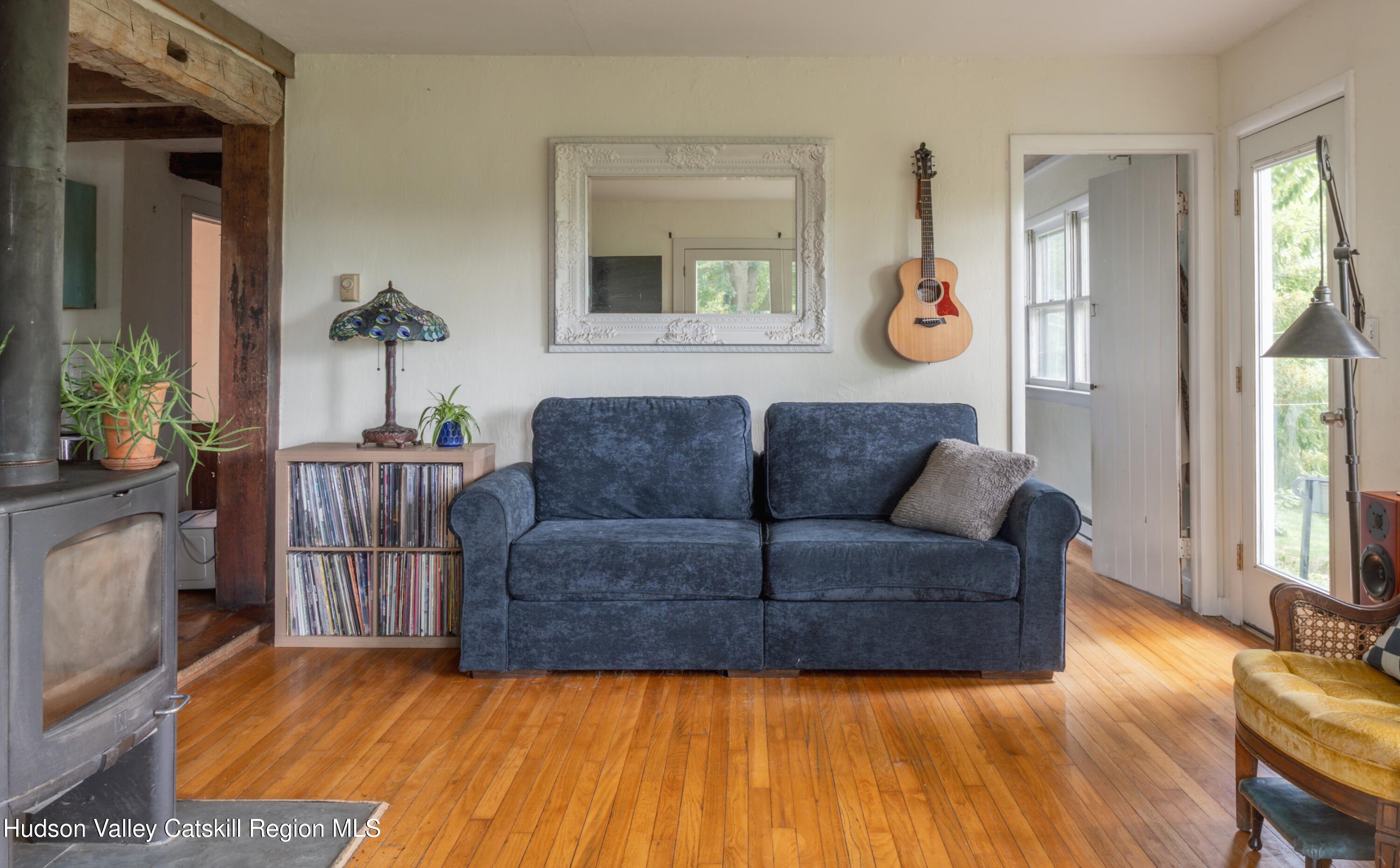 99 Spoorenburgh Road Athens, NY 12015 - Photo 15 of 39 a living room with furniture and a large window