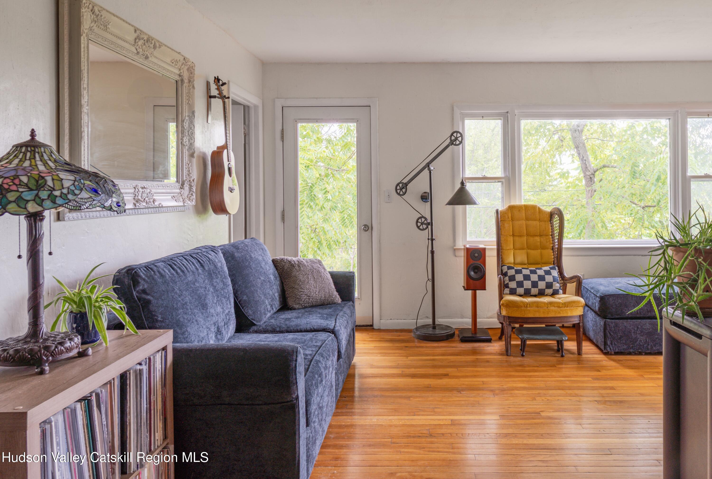 99 Spoorenburgh Road Athens, NY 12015 - Photo 17 of 39 a living room with furniture and a large window