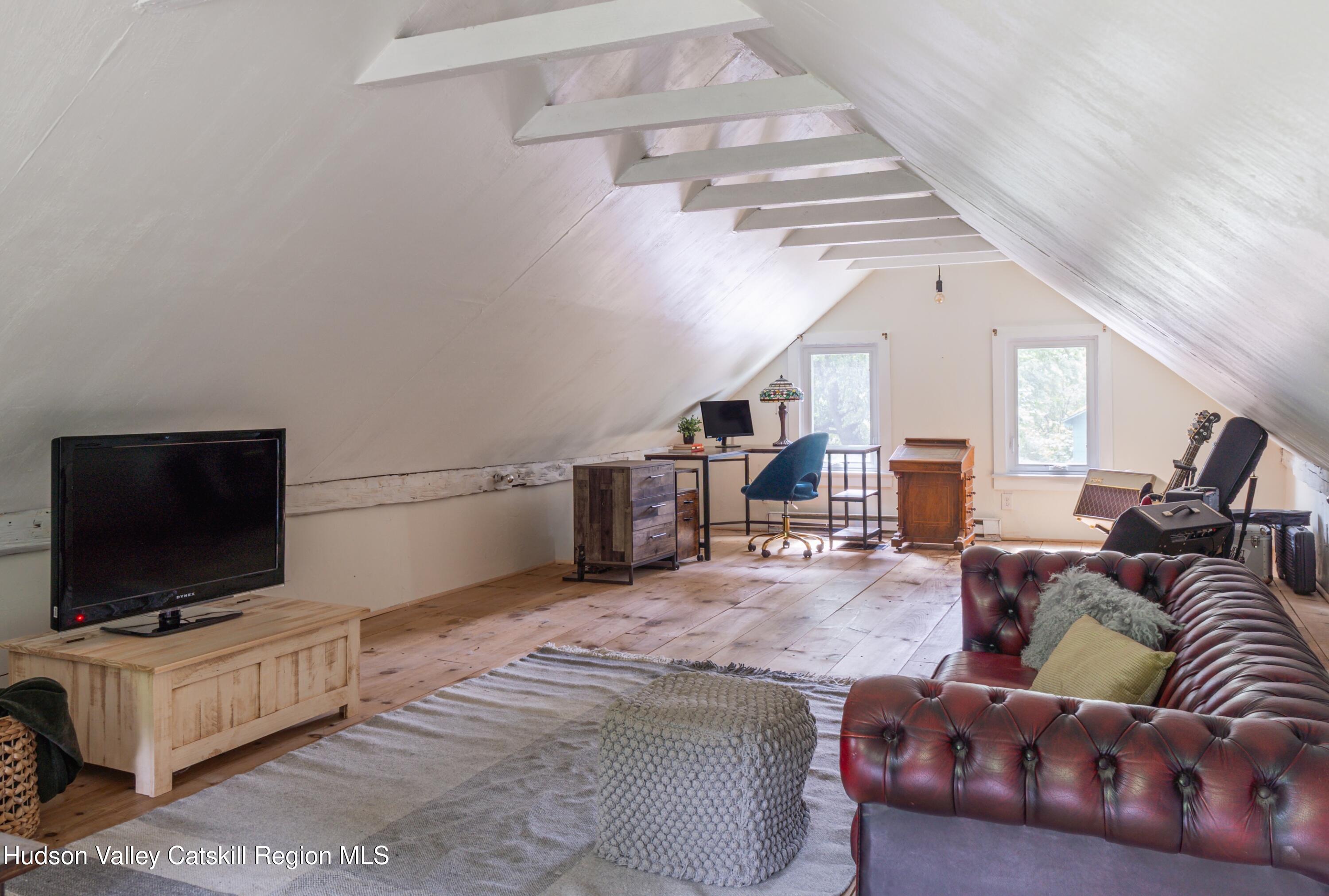 99 Spoorenburgh Road Athens, NY 12015 - Photo 24 of 39 a living room with furniture and a flat screen tv