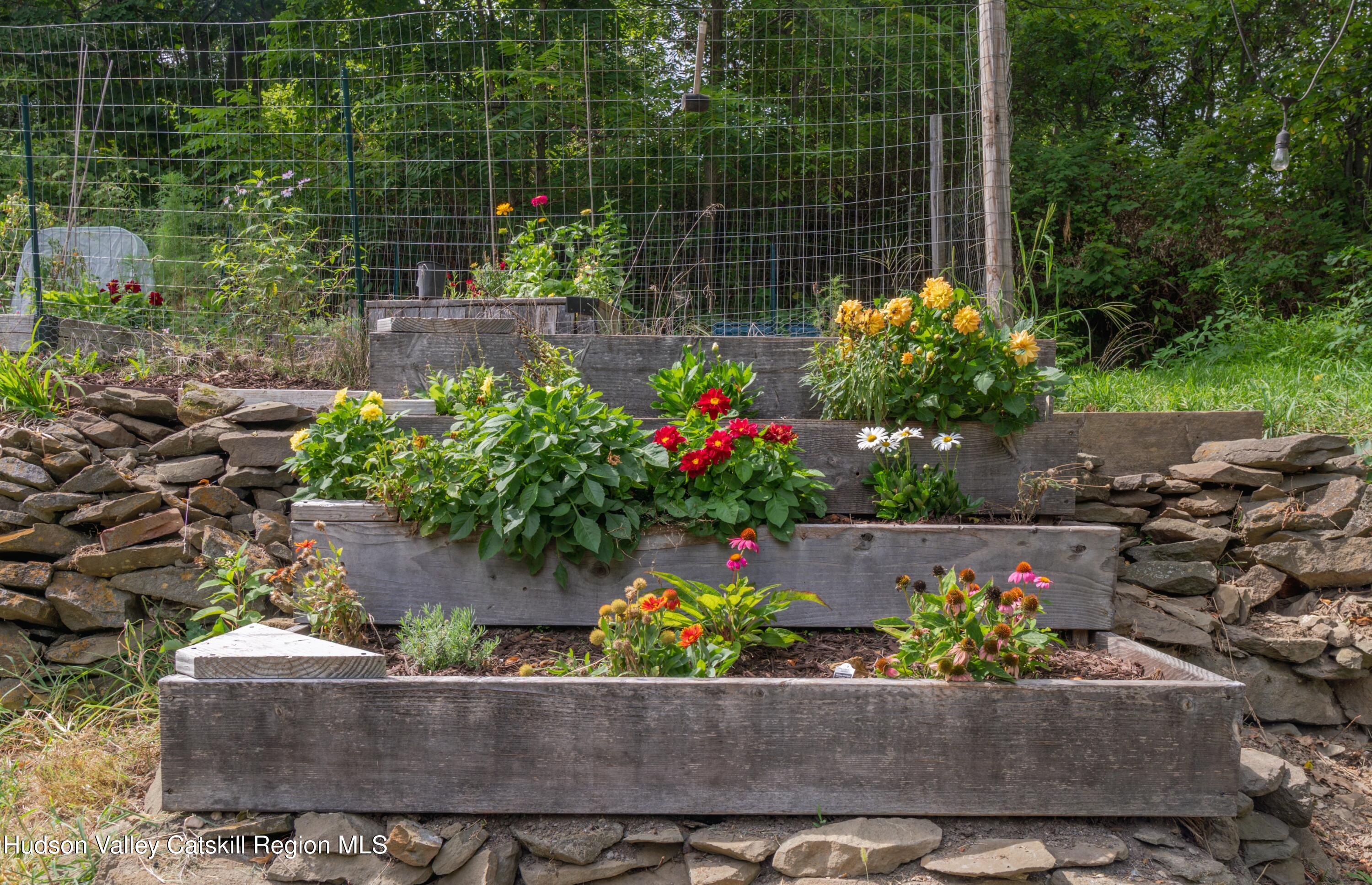 99 Spoorenburgh Road Athens, NY 12015 - Photo 30 of 39 a bunch of flowers are in a garden