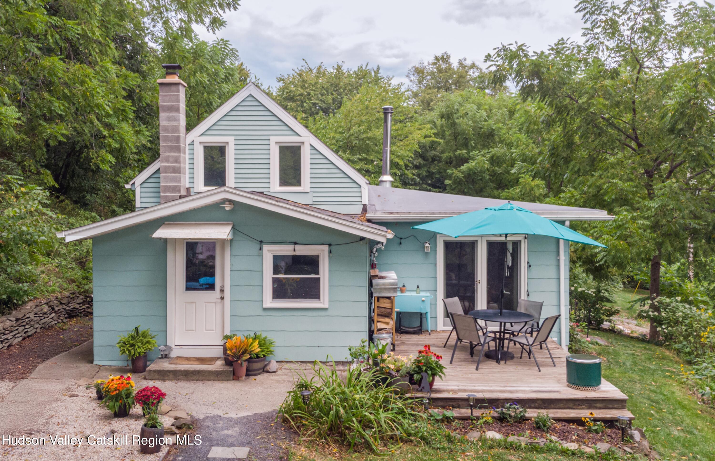 99 Spoorenburgh Road Athens, NY 12015 - Photo 36 of 39 a view of a house with table and chairs in patio