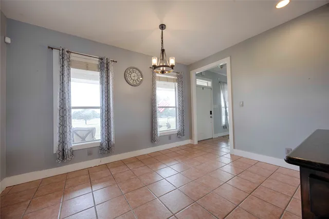 a kitchen with kitchen island granite countertop a sink and refrigerator