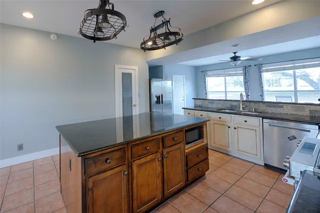 a kitchen with a refrigerator and a sink