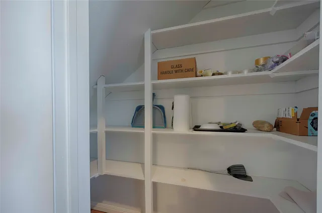 a dining hall with a window and a refrigerator