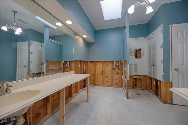 a spacious bedroom with a bed and a flat screen tv