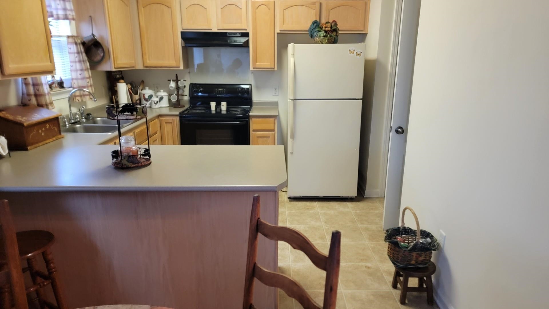 1017 Milano Cove Memphis, TN 38018 - Photo 7 of 20 a kitchen with a refrigerator and a stove top oven
