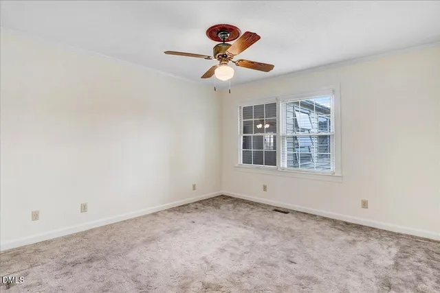 a view of room with a ceiling fan and window