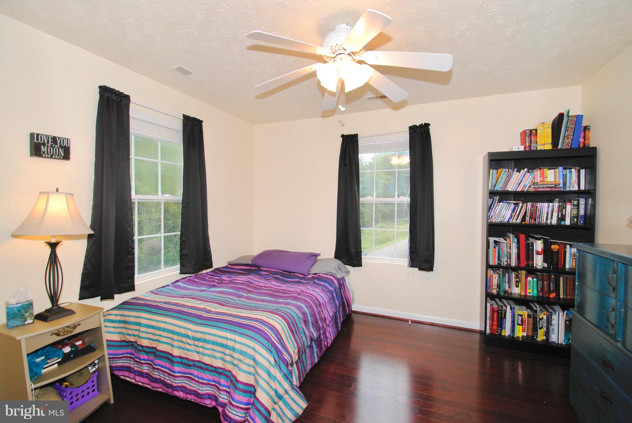 302 Fairhaven Road Tracys Landing, MD 20779 - Photo 14 of 24 a bedroom with a bed a book shelf and a window