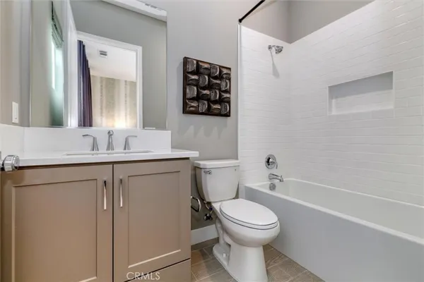 a bathroom with a toilet sink a mirror a vanity and shower