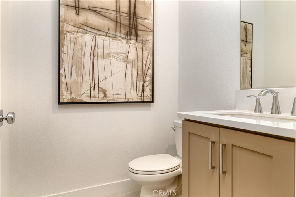 29606 Paseo Capilla Valencia, CA 91354 - Photo 13 of 26 a bathroom with a granite countertop sink and a toilet