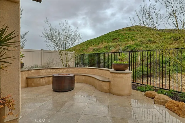 a view of a patio with iron fence