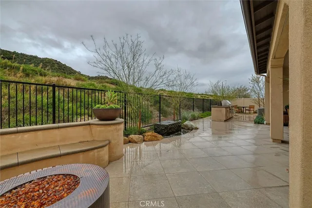 a balcony with couple of white furniture and outdoor space