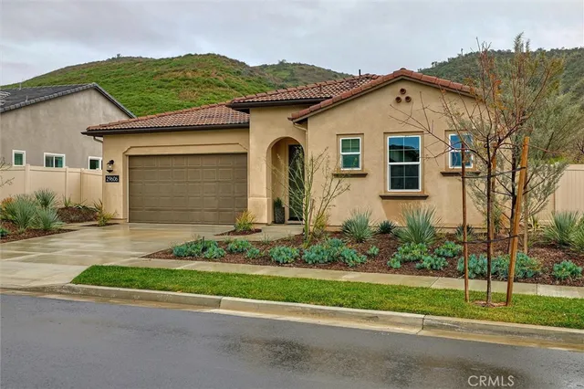 a front view of a house with a garden
