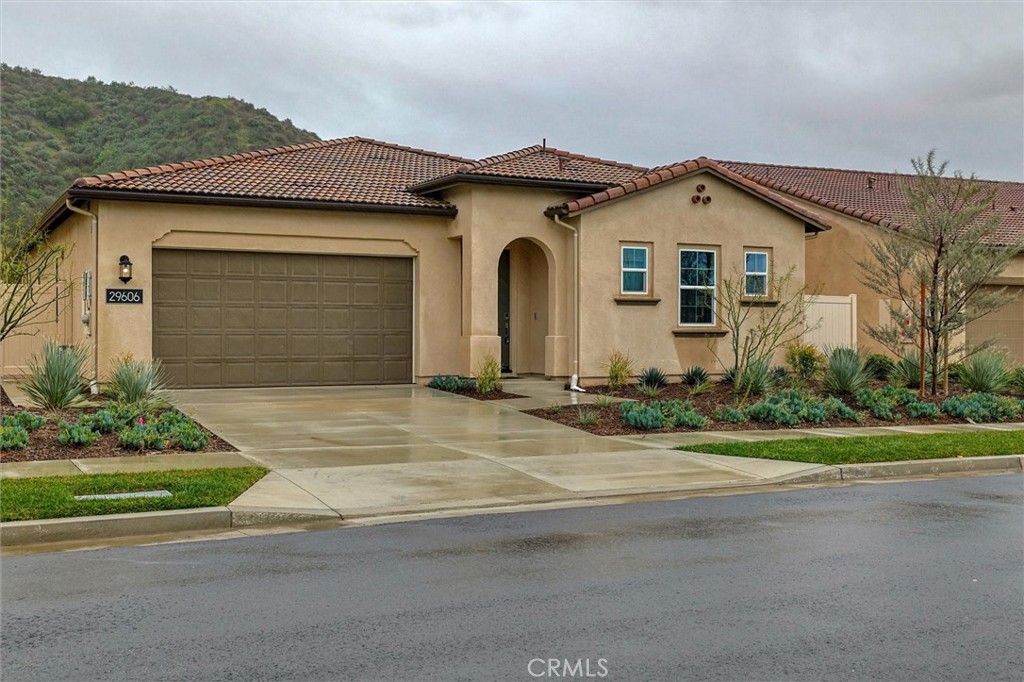 29606 Paseo Capilla Valencia, CA 91354 - Photo 5 of 26 a front view of a house with a yard and garage