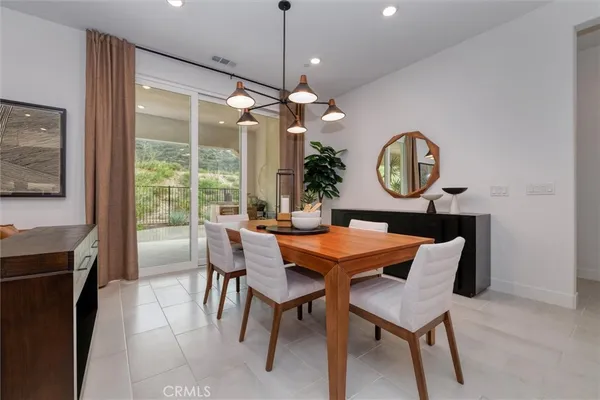 a dining room with a wooden table and chairs