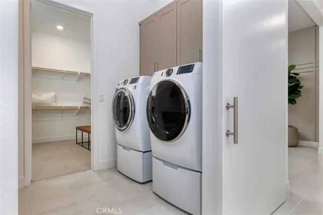 a utility room with sink dryer and washer