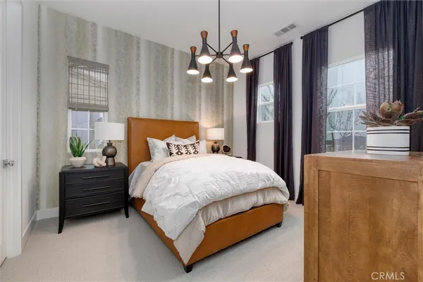 a bedroom with a bed dresser and a window