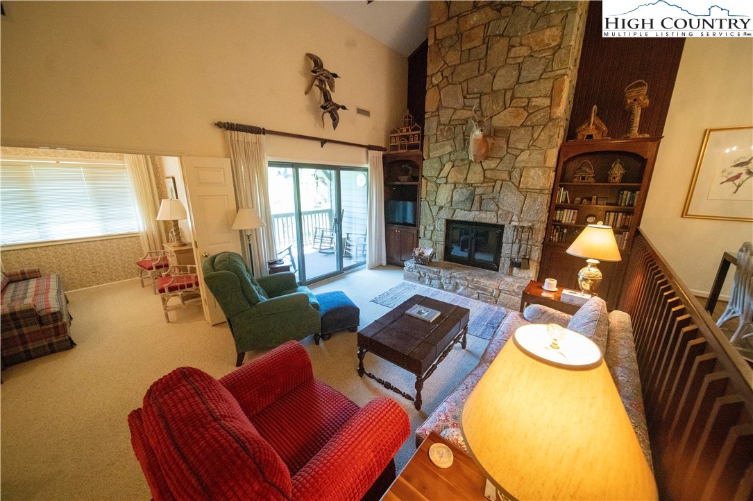 185 Waterside Drive, Unit 20 OF WALNUT 5 Blowing Rock, NC 28605 - Photo 2 of 15 a living room with furniture a fireplace and a flat screen tv