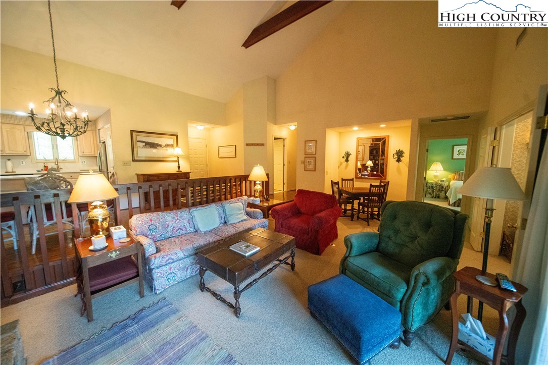 185 Waterside Drive, Unit 20 OF WALNUT 5 Blowing Rock, NC 28605 - Photo 3 of 15 a living room with furniture and a chandelier