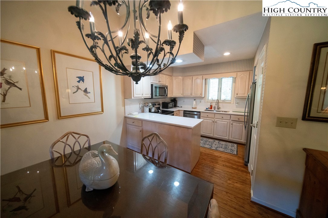 185 Waterside Drive, Unit 20 OF WALNUT 5 Blowing Rock, NC 28605 - Photo 4 of 15 a kitchen with granite countertop a stove and a refrigerator