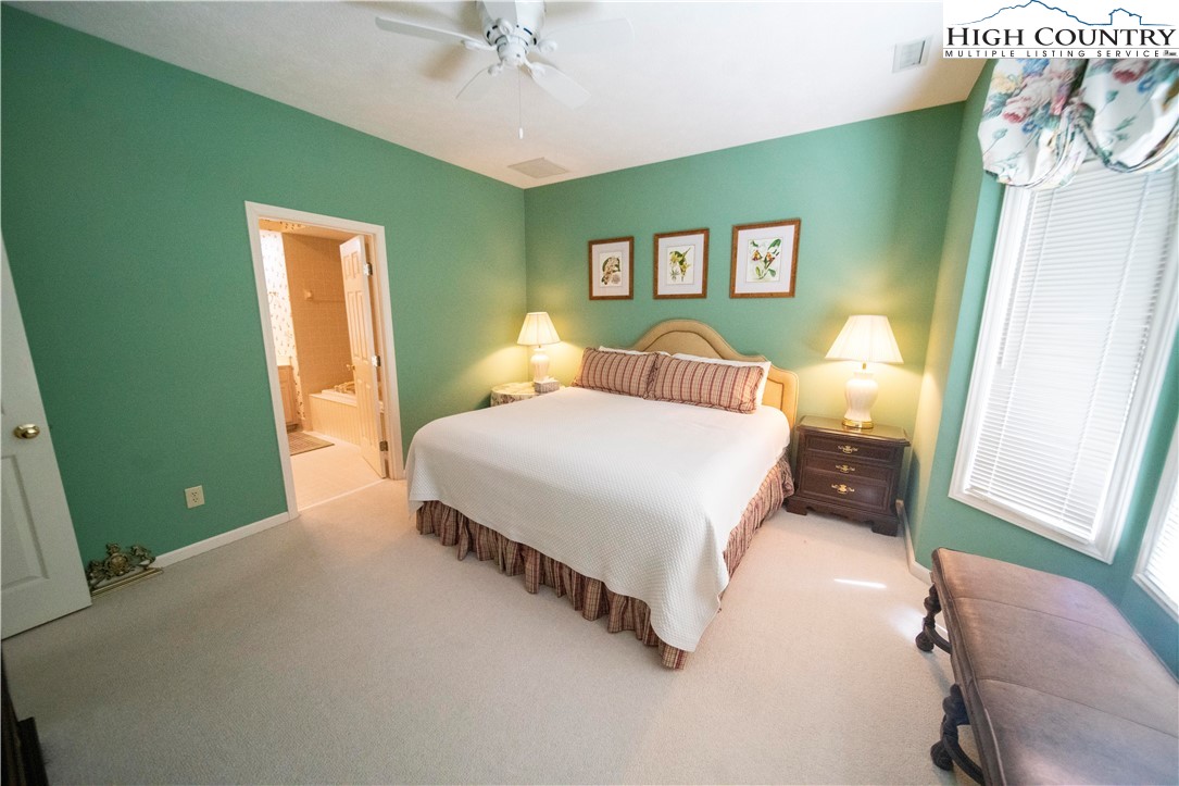 185 Waterside Drive, Unit 20 OF WALNUT 5 Blowing Rock, NC 28605 - Photo 9 of 15 a bedroom with a bed and a chandelier