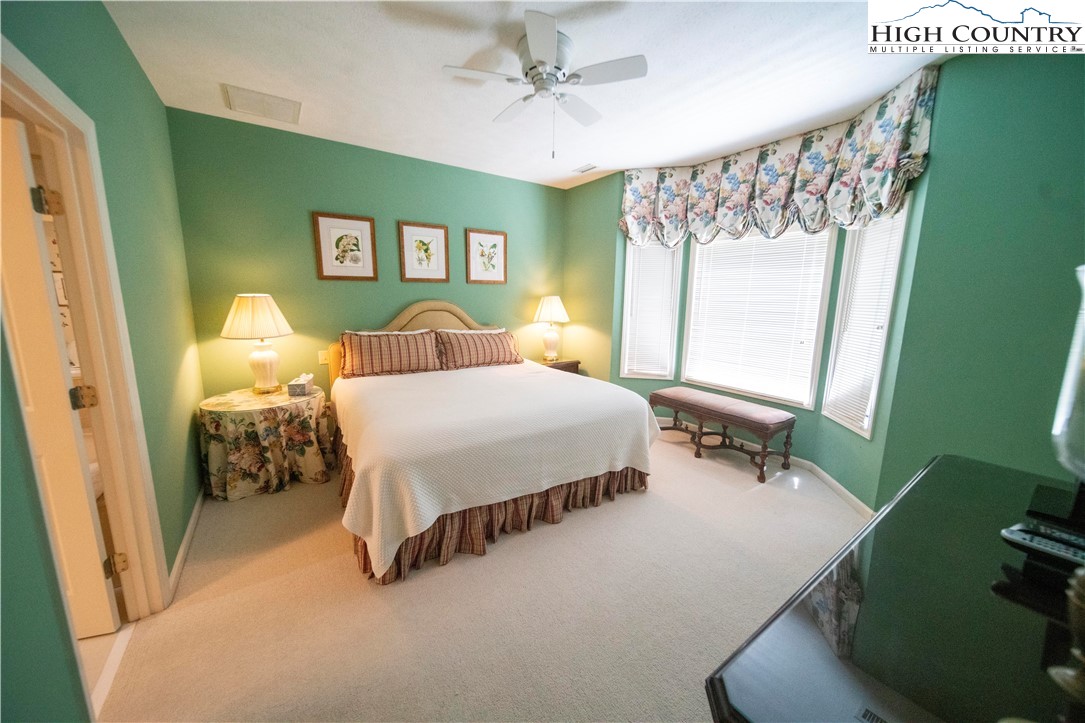 185 Waterside Drive, Unit 20 OF WALNUT 5 Blowing Rock, NC 28605 - Photo 10 of 15 a bedroom with a bed mirror and a window