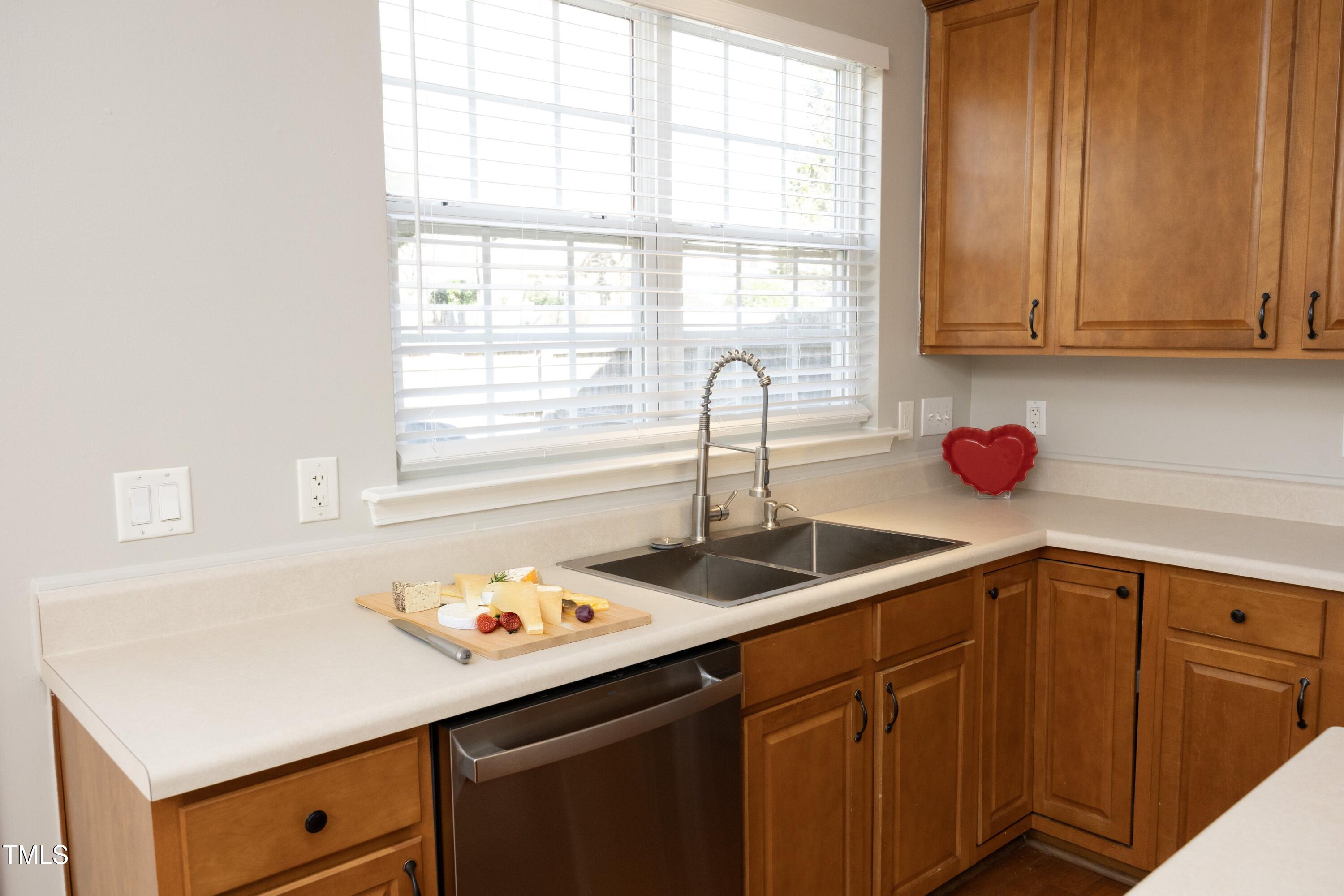 1525 Nealstone Way Raleigh, NC 27614 - Photo 16 of 47 a kitchen with a sink cabinets and window