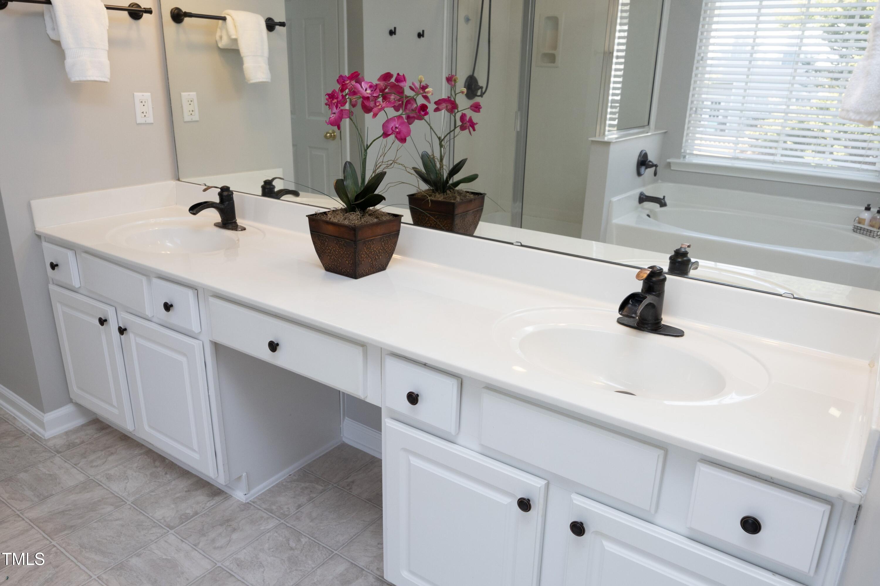1525 Nealstone Way Raleigh, NC 27614 - Photo 27 of 47 a bathroom with a sink a vanity and a mirror
