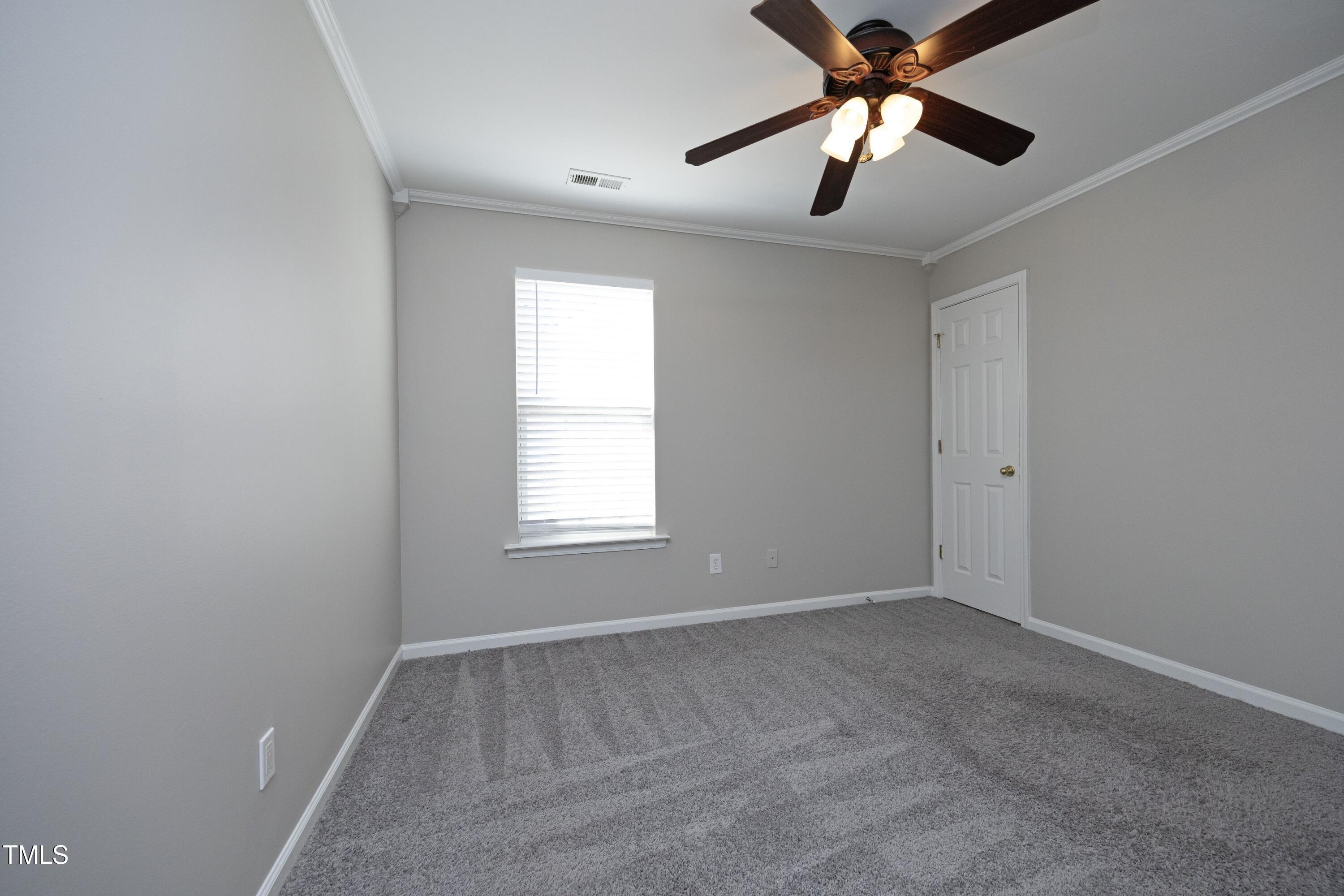 1525 Nealstone Way Raleigh, NC 27614 - Photo 33 of 47 an empty room with a window and a fan