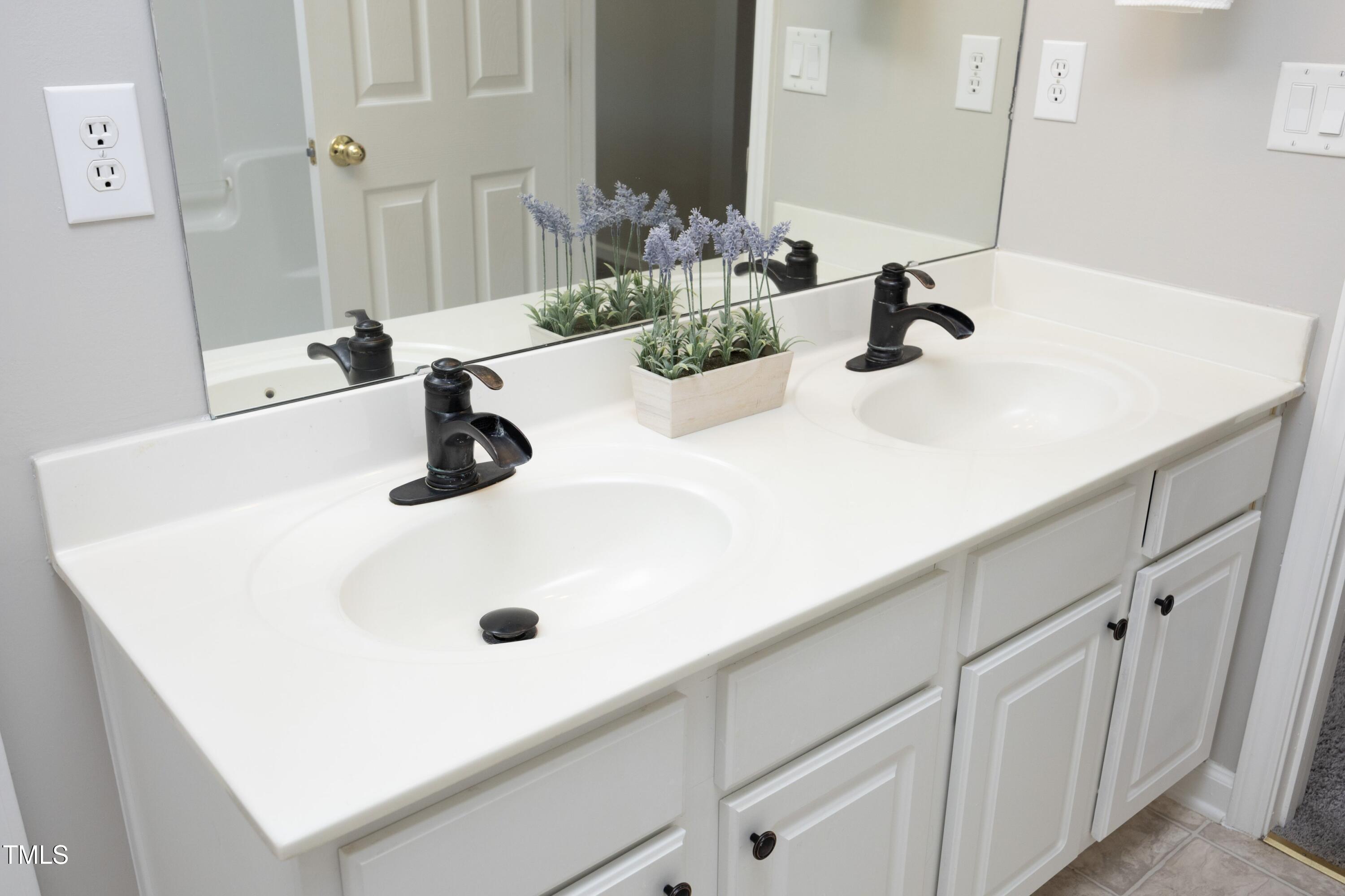 1525 Nealstone Way Raleigh, NC 27614 - Photo 36 of 47 a bathroom with a sink and a mirror