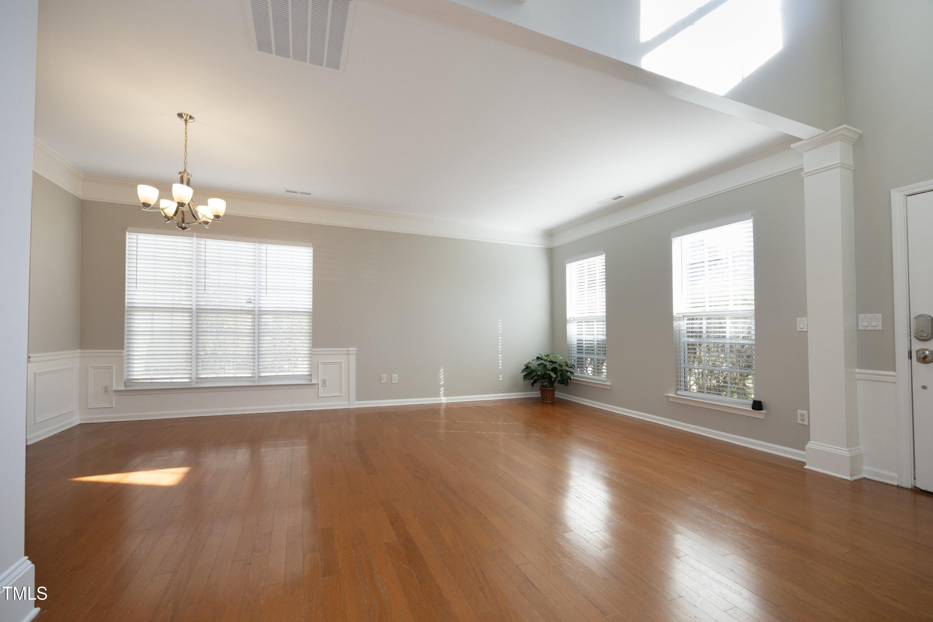 1525 Nealstone Way Raleigh, NC 27614 - Photo 5 of 47 a view of an empty room with wooden floor and a window