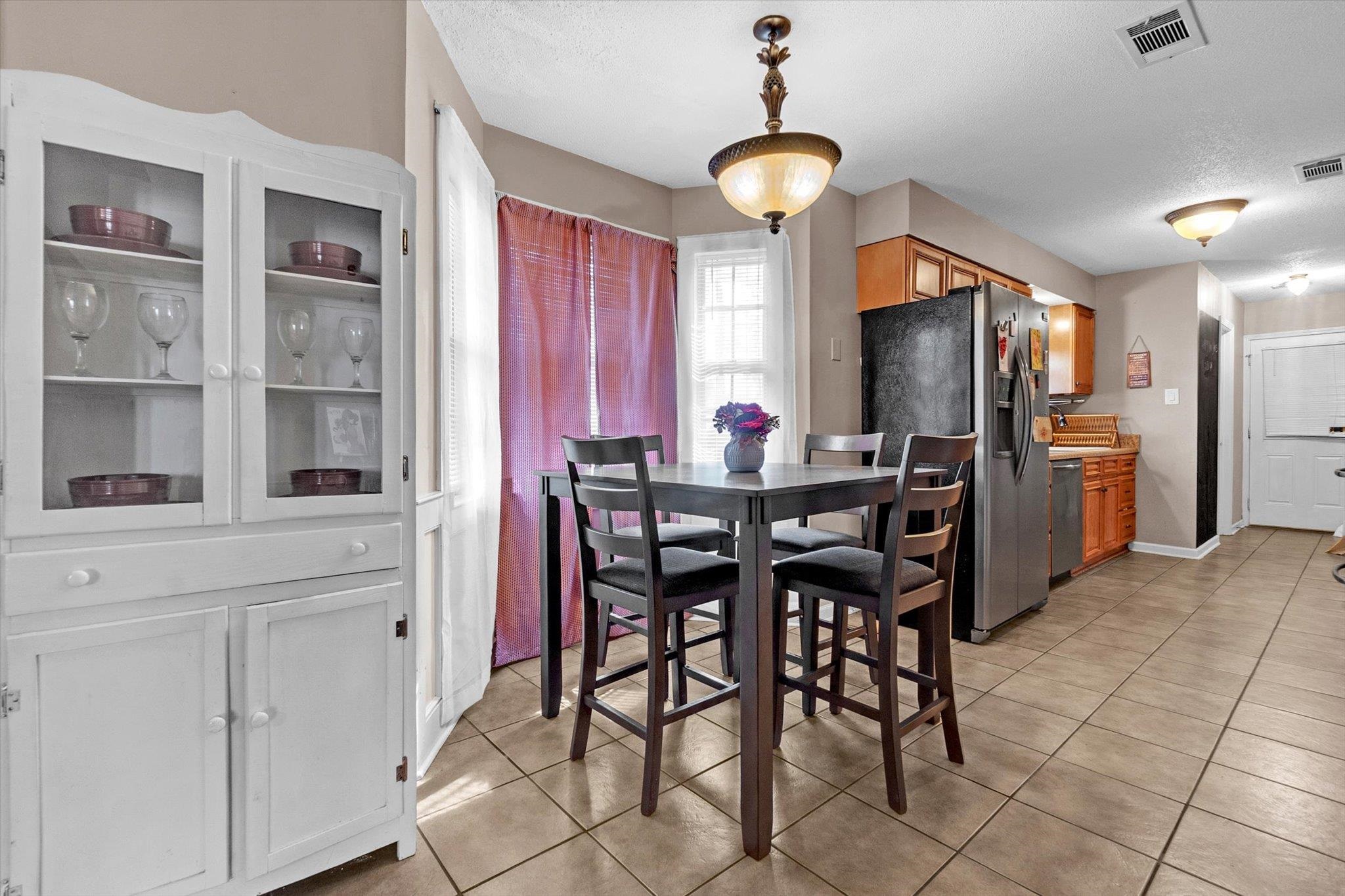 480 Friars Point Lane Memphis, TN 38018 - Photo 11 of 26 Dining room with light tile patterned flooring and a textured ceiling
