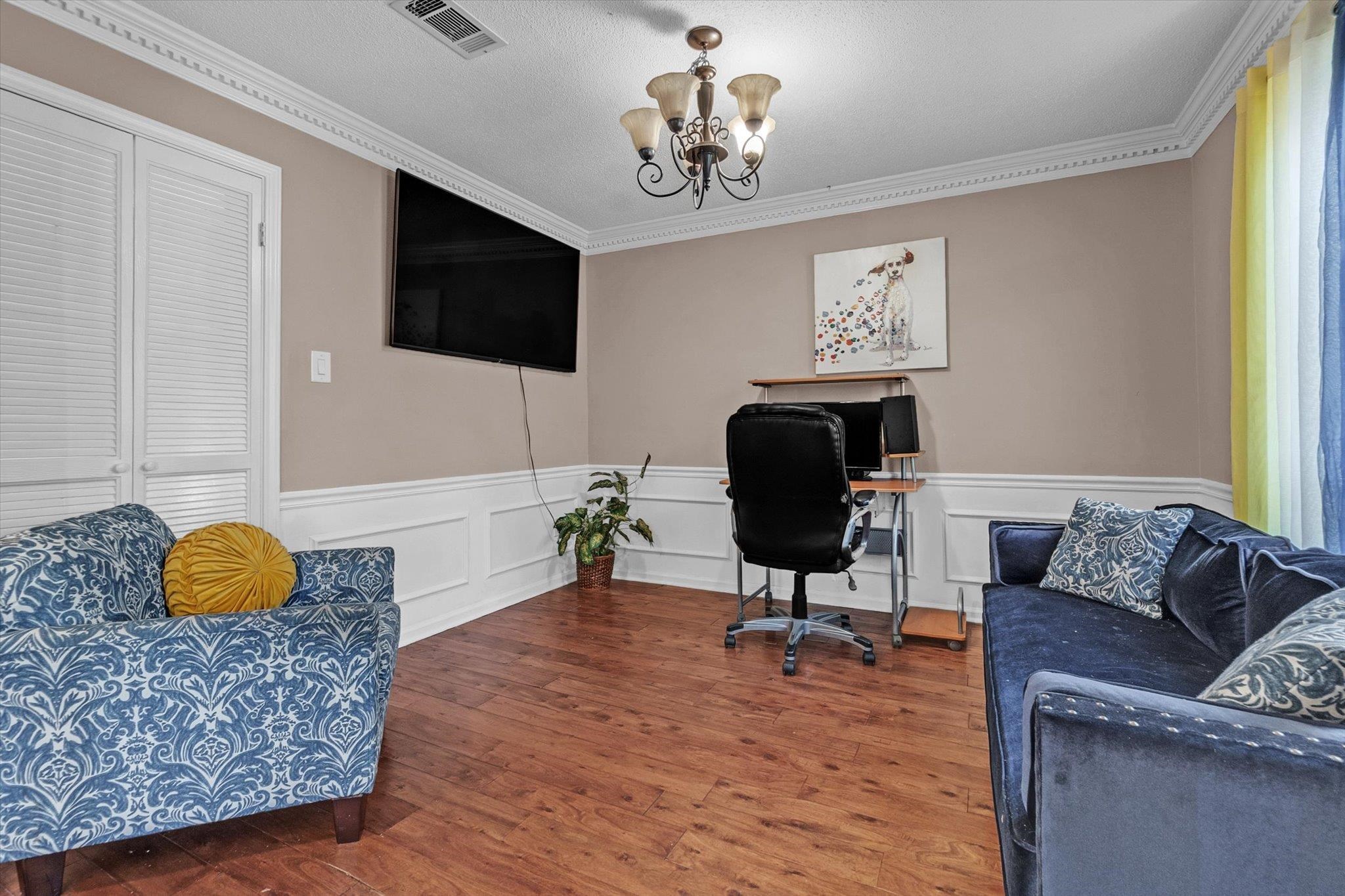 480 Friars Point Lane Memphis, TN 38018 - Photo 15 of 26 Office area with crown molding, a decorative wall, wood-type flooring, a chandelier, and a wainscoted wall