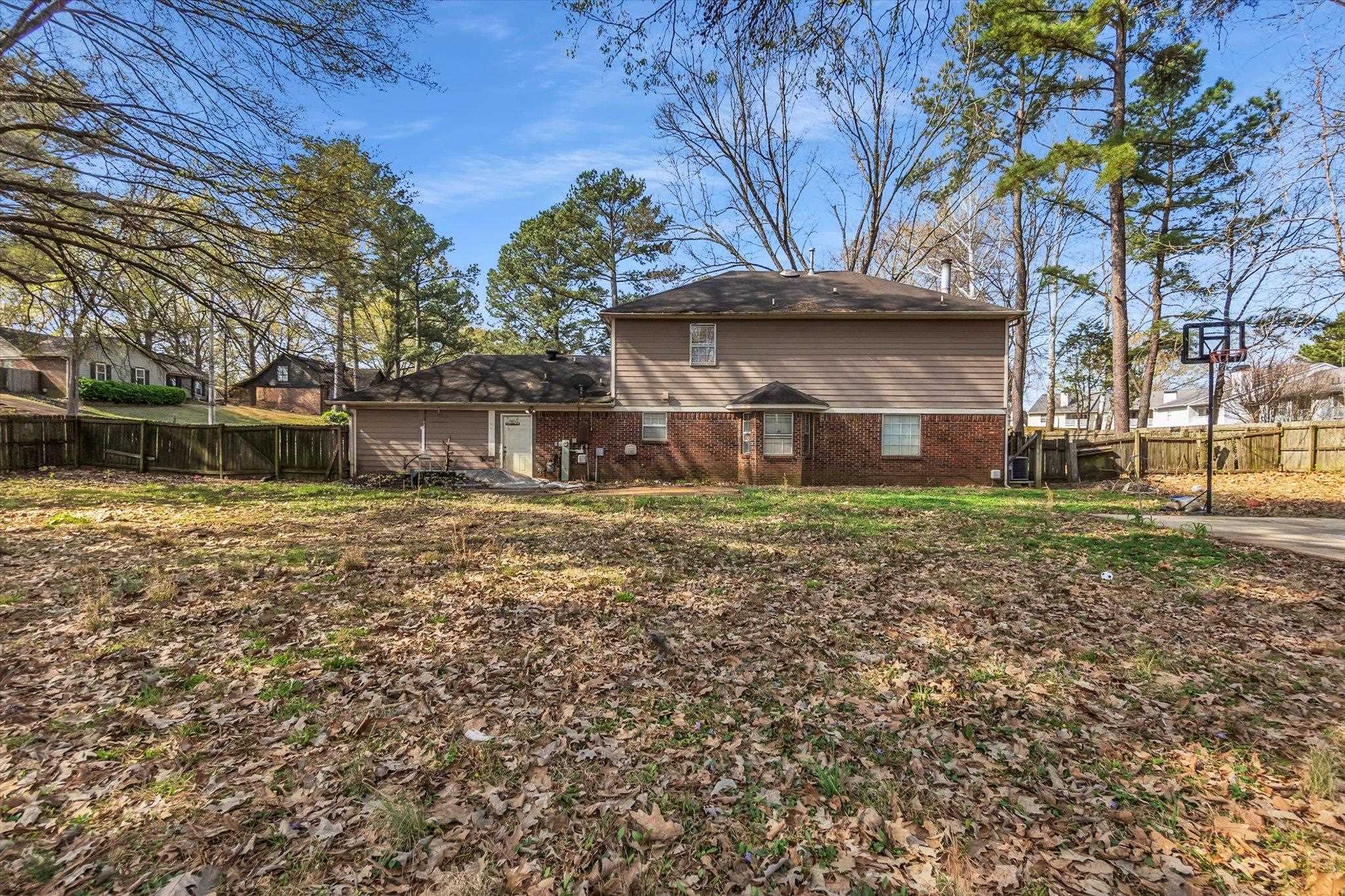480 Friars Point Lane Memphis, TN 38018 - Photo 26 of 26 Back of house with brick siding, a fenced backyard, and a chimney