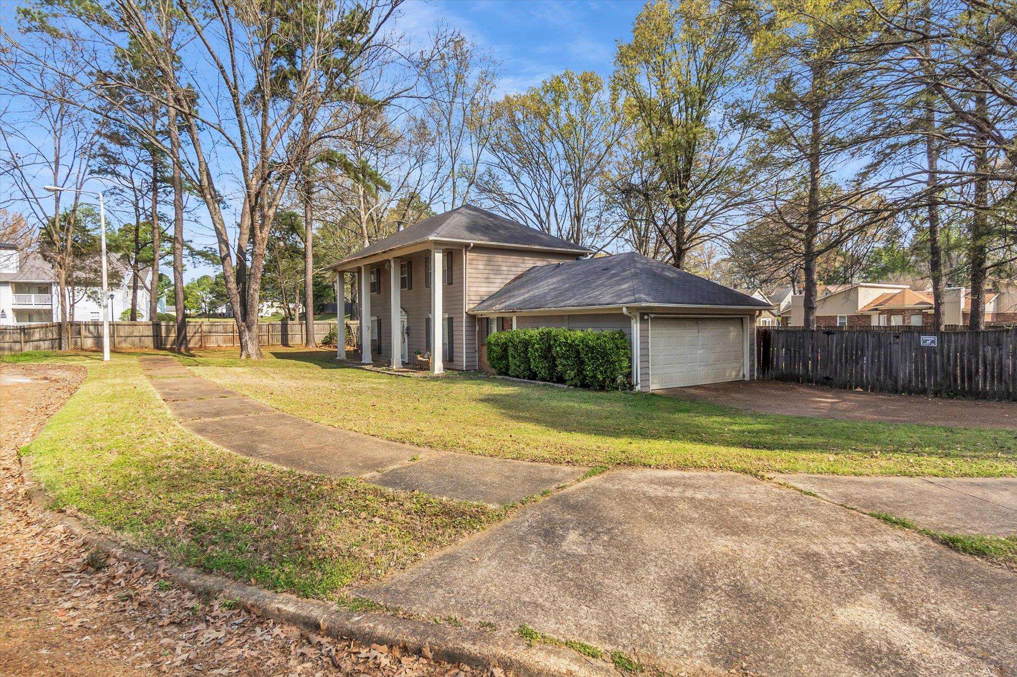 480 Friars Point Lane Memphis, TN 38018 - Photo 3 of 26 View of property exterior featuring driveway, an attached garage, and roof with shingles