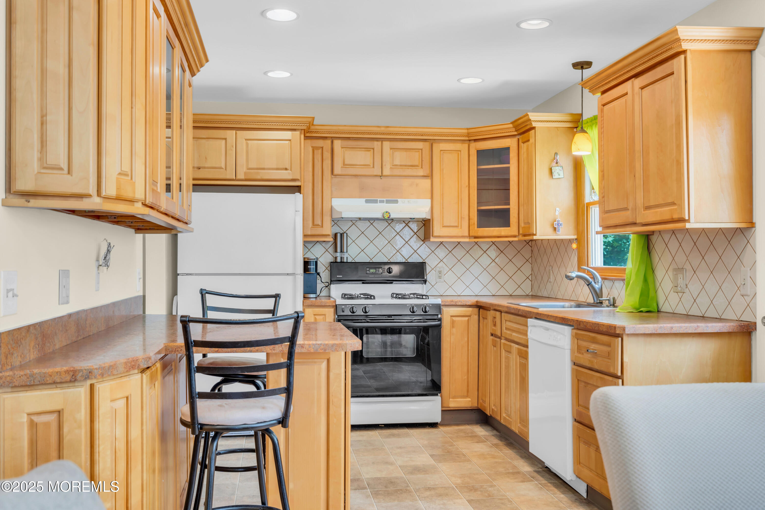 104 Frede Drive Brick, NJ 08724 - Photo 12 of 62 a kitchen with kitchen island granite countertop wooden cabinets and stainless steel appliances