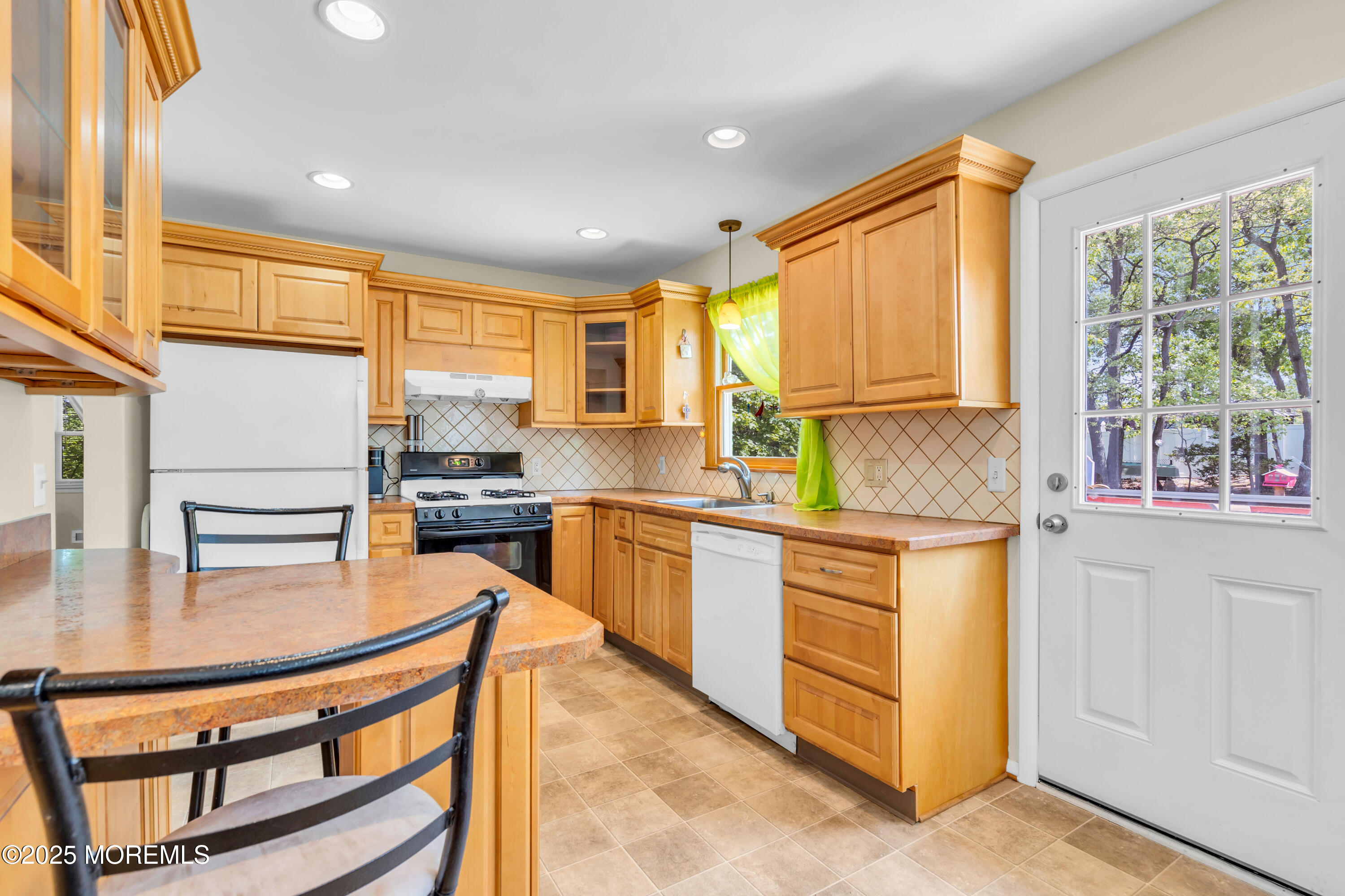 104 Frede Drive Brick, NJ 08724 - Photo 16 of 62 a kitchen with stainless steel appliances granite countertop a stove a sink and a refrigerator