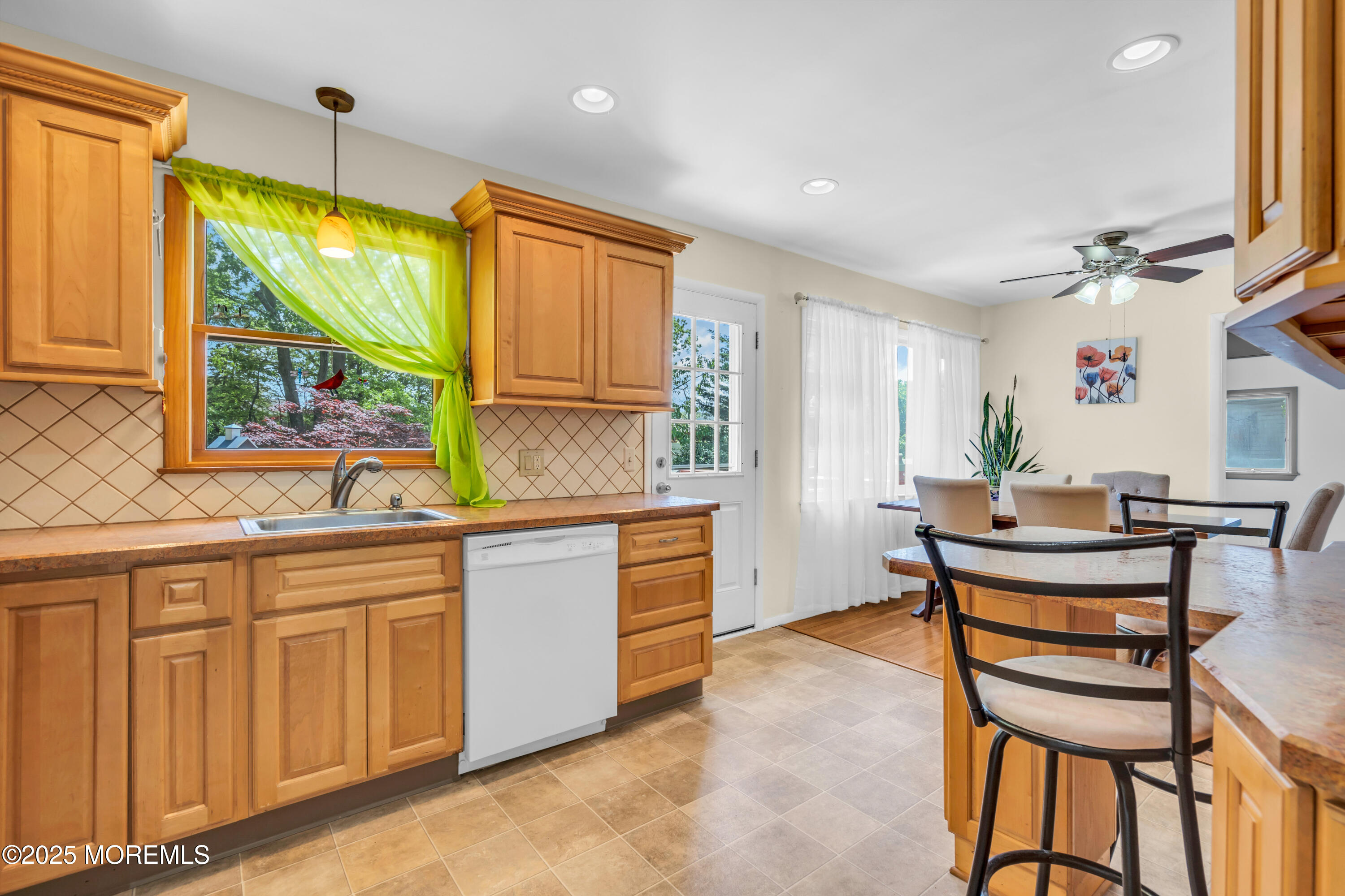 104 Frede Drive Brick, NJ 08724 - Photo 17 of 62 a kitchen with sink cabinets and dining table