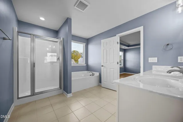 a large bathroom with a granite countertop sink a toilet and shower