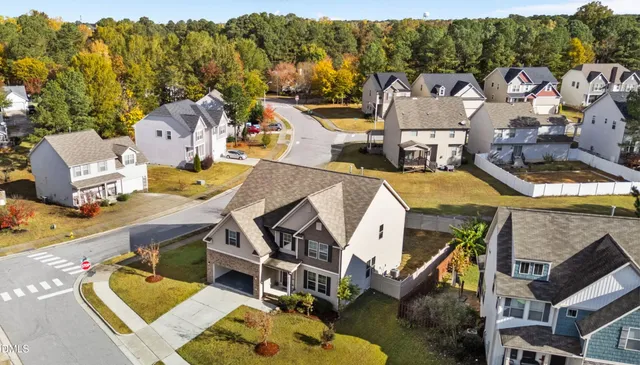 an aerial view of a house with swimming pool and ocean view