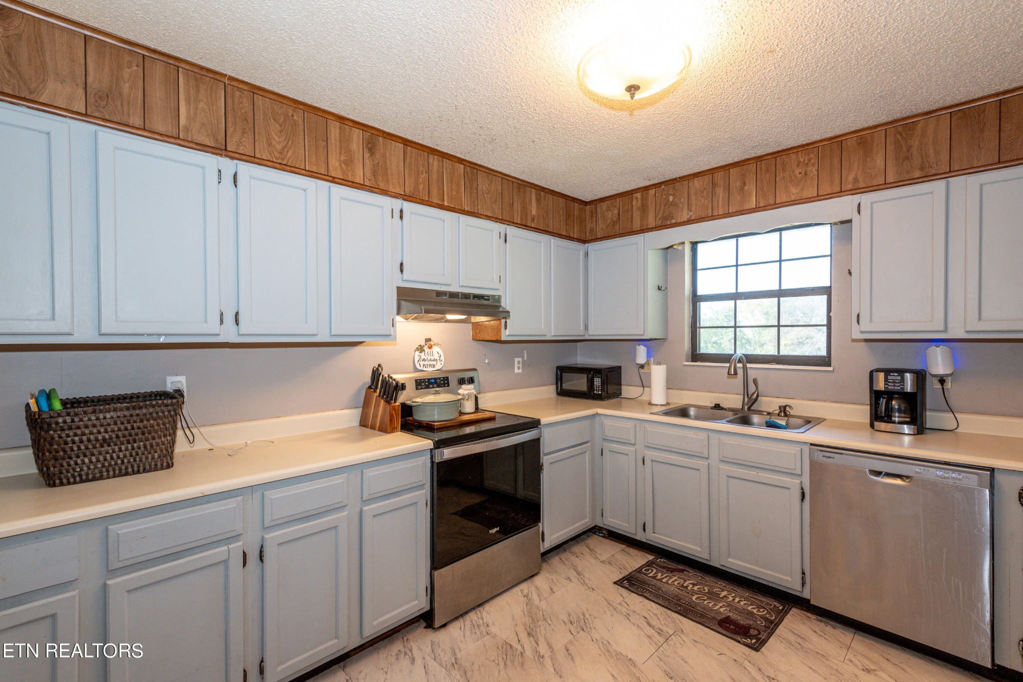 445 Foss Road Maryville, TN 37801 - Photo 9 of 40 a kitchen with a sink a window and cabinets