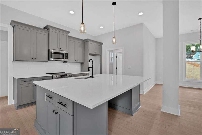 25 Everwood Court Rome, GA 30161 - Photo 9 of 37 a kitchen with kitchen island a sink appliances and cabinets
