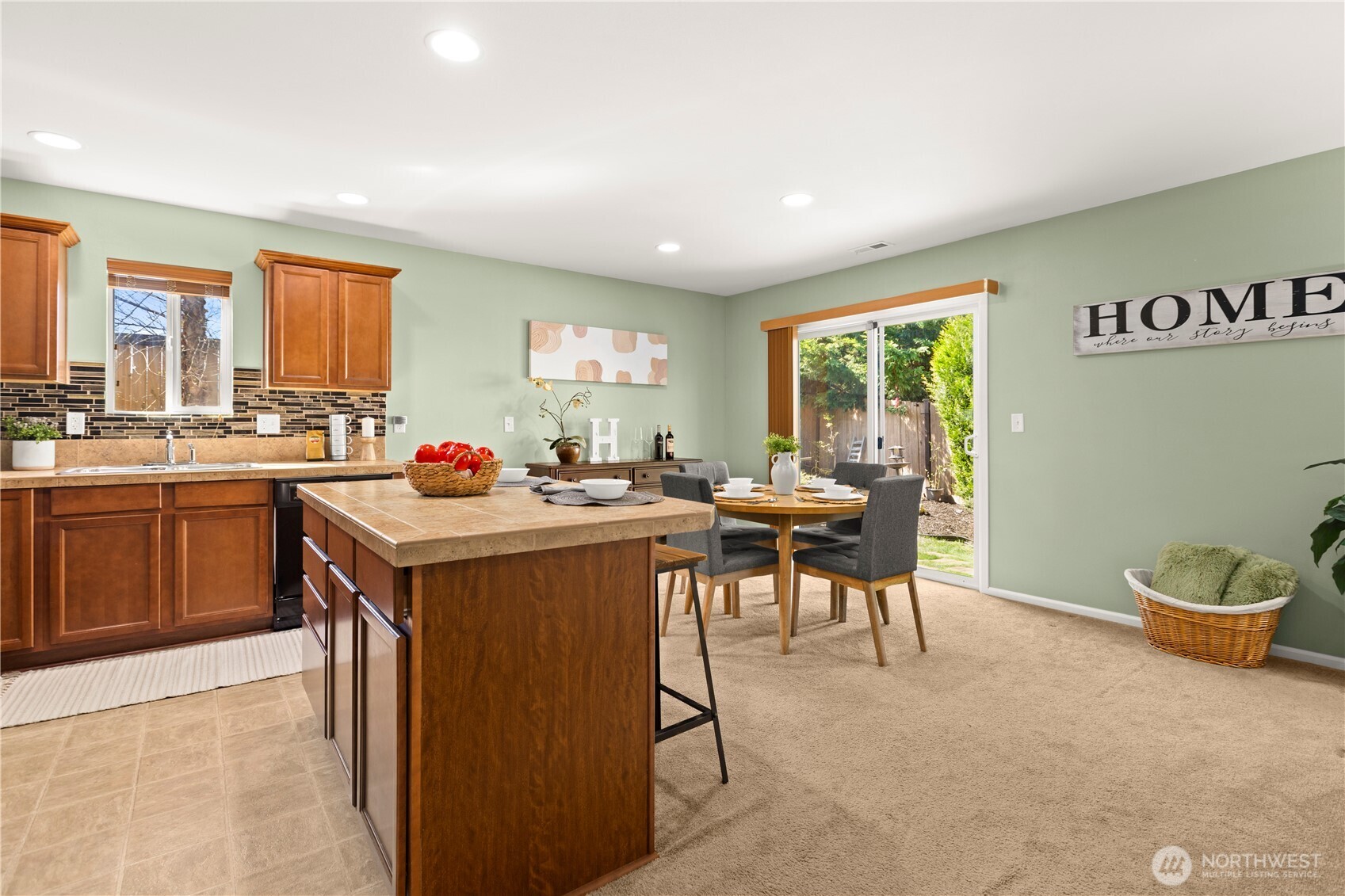 24002 Southeast 262nd Street Maple Valley, WA 98038 - Photo 11 of 30 a open kitchen with a sink dining table and chairs